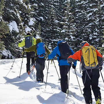 Men hiking backcountry with ski skins and backpacks