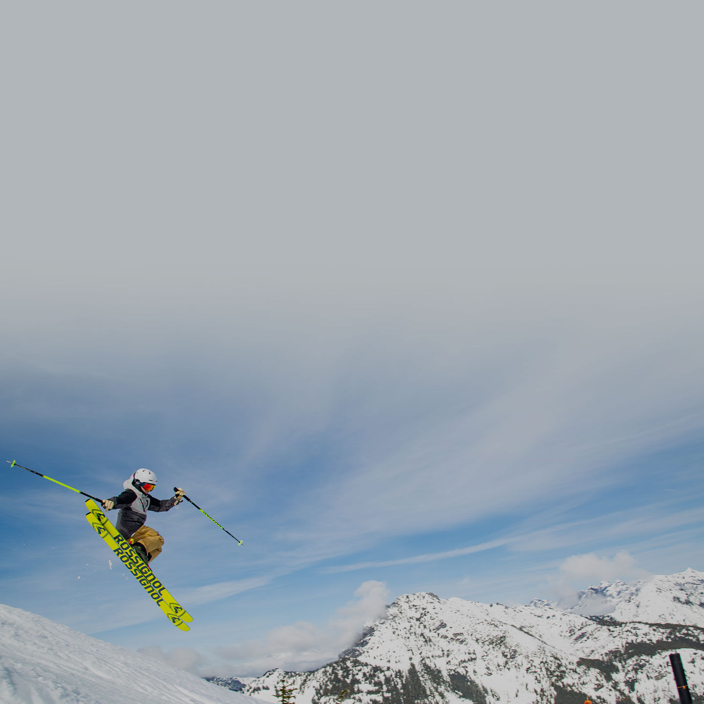 skier launching through the air off jump