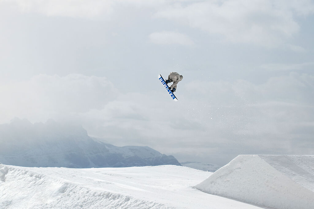 Snowboarder hitting a huge park jump